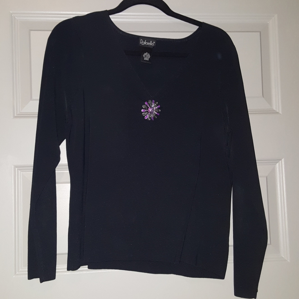 Black top with purple brooch embellishment